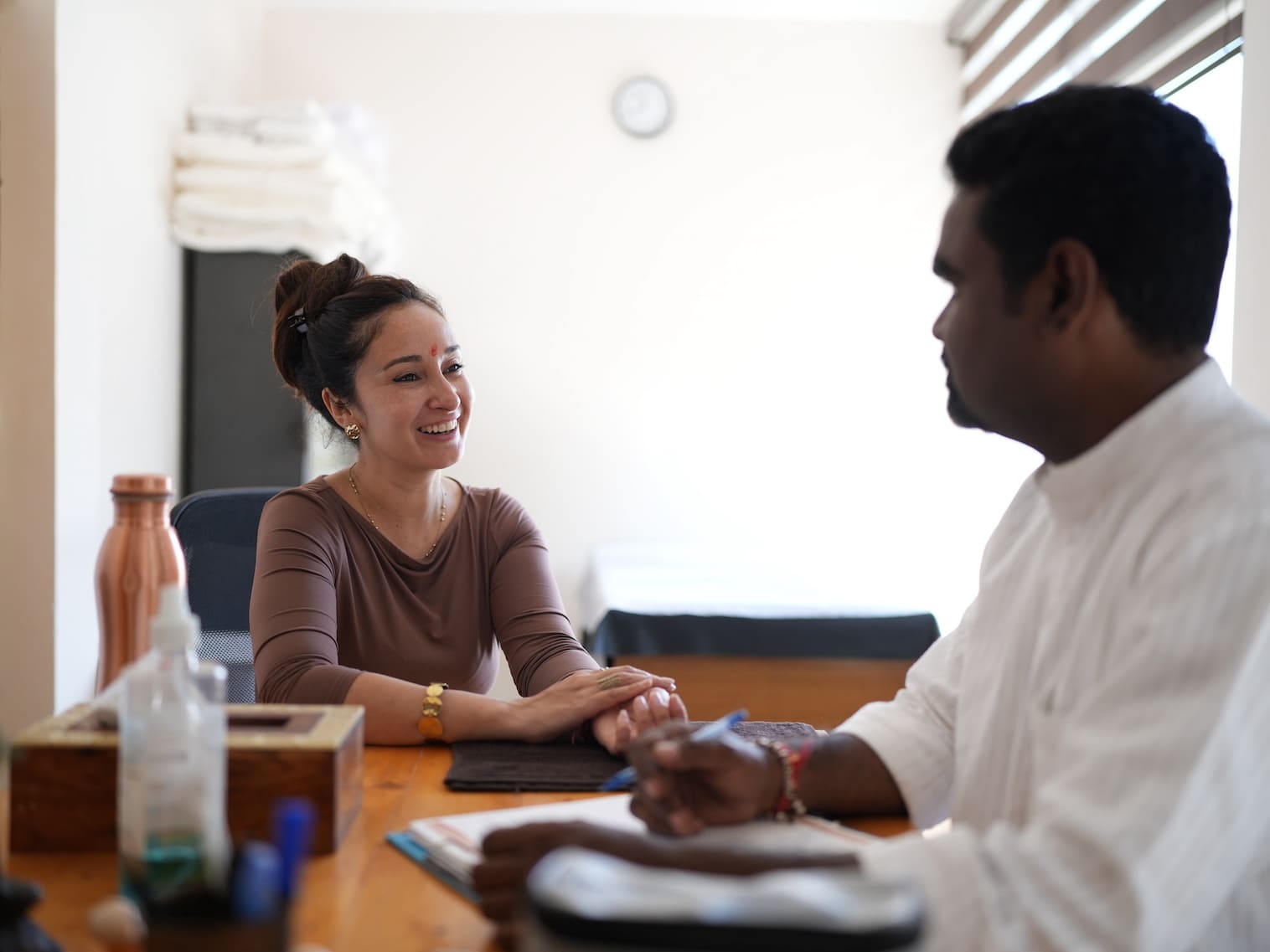 Smiling guest in personal Ayurveda doctor consultation