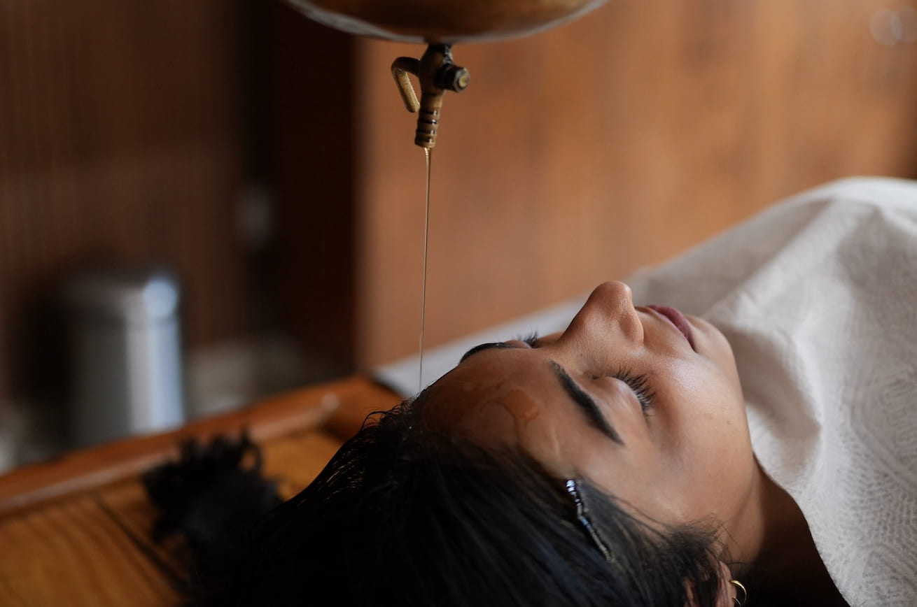 Shirodhara — warm oil poured on forehead during Ayurveda treatment